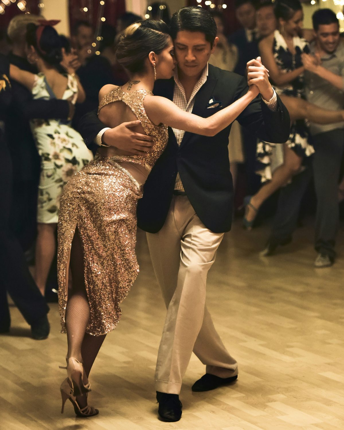 A couple dancing Argentine tango in a candlelit hall